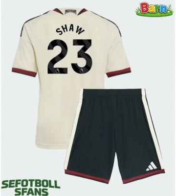 Manchester United Luke Shaw #23 Tredjeställ Barn 2026-27 Kortärmad (+ Korta byxor)